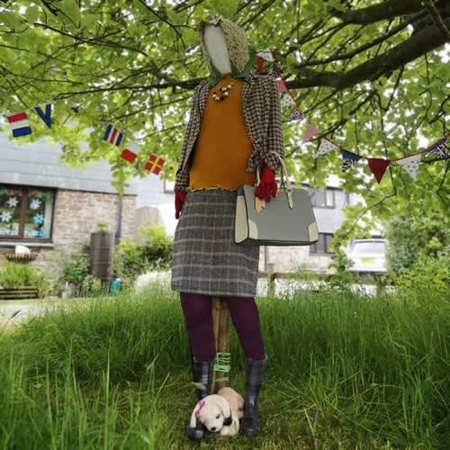 Photo Gallery Image - 'The Queen' elegantly attired taking a walk with her dog